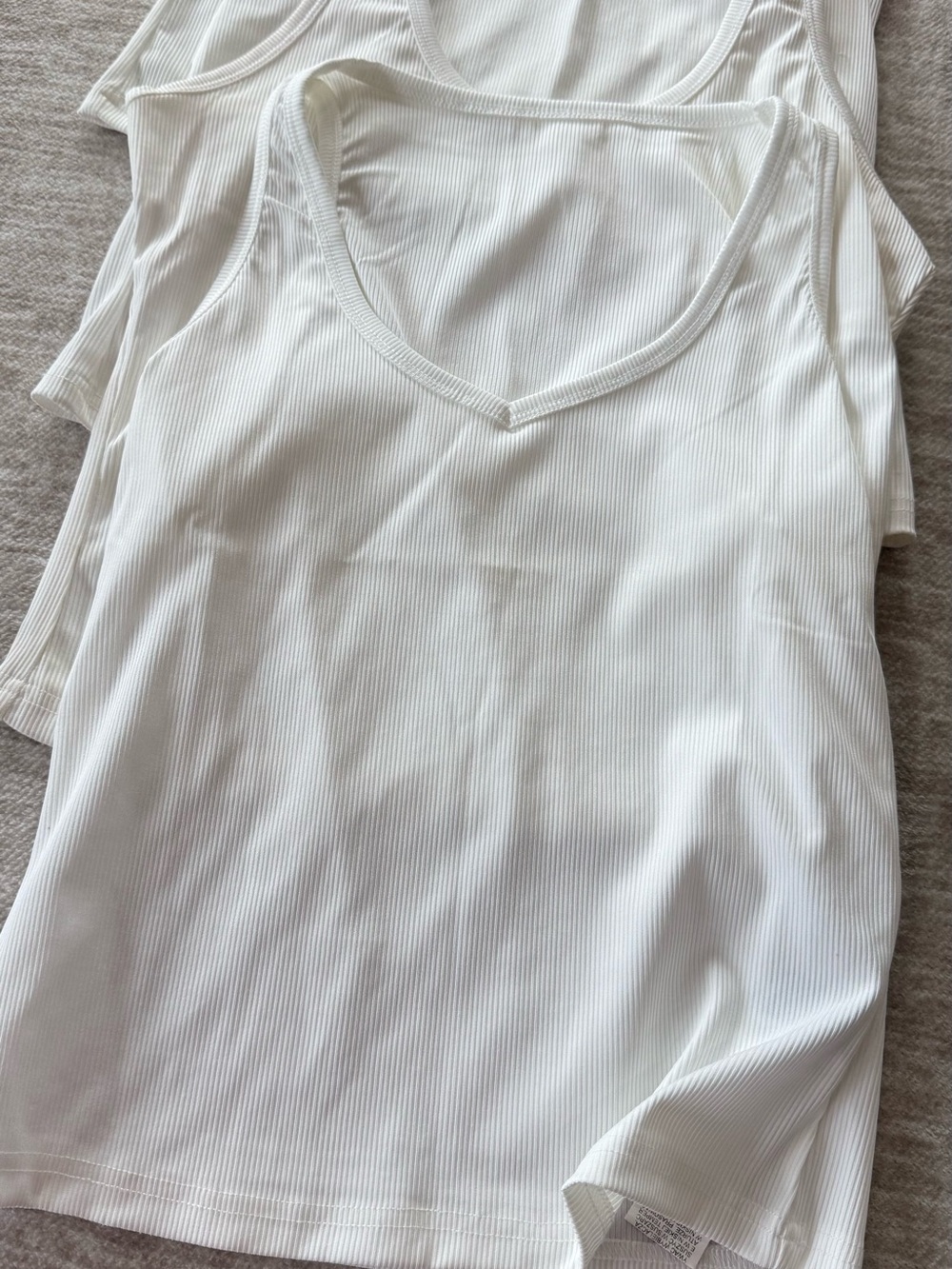 Lot of 4 white tank tops.